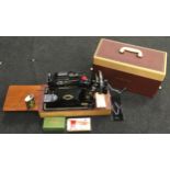 Vintage Singer model 99K electric sewing machine in clean condition with accessories.