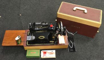 Vintage Singer model 99K electric sewing machine in clean condition with accessories.