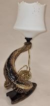 A vintage lampstand formed from an animal horn.