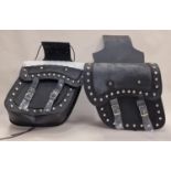 A pair of new motorcycle panniers with decorative studwork.