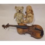 Two vintage teddy bears together with an antique violin.