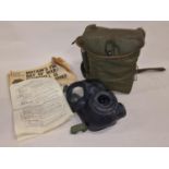 Military grade gas mask in case together an early Daily Mirror newspaper from 1939