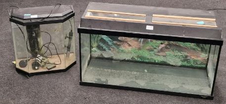 A glass Jowel Aquarium together with a smaller fish tank.