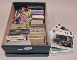 A box containing a collection of vintage and modern collectors carrds.