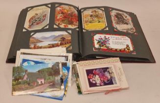 Vintage album containing a collection of topographical postcards with some loose.