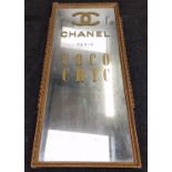Large gilt framed mirror with applied advertising decoration 127x53cm.