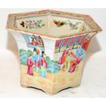 Oriental Famille Rose planter of hexagonal form with garden scenes. 18cms tall