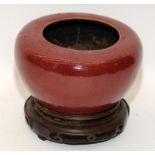 Sang de Bouef oriental-style brush washer on a Chinese hardwood stand. H 11.5cm
