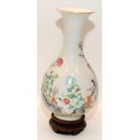 A Chinese Famille rose pear shaped vase, painted in poly chrome enamels with prunus trees and cranes