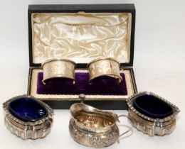 A collection of hallmarked silver items to include a cased pair of napkin rings, a small creamer and