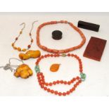 A collection of Chinese amber to include bracelet, pendant, two wood cased items and an amber plaque