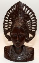 Indonesian wood carved head and shoulders figure of a woman wearing headdress. 30cms tall