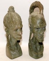 Two carved stone busts of an African man and woman. Tallest is 31cms