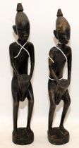 Pair of wooden carved African drummer figures, 31cms tall