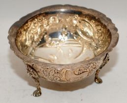 Hallmarked silver bowl on three feet with repousse decoration featuring a hound and a deer. Hallmark