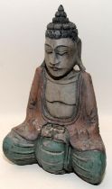 Vintage carved figure of Buddha with signs of faded paint. 27cms tall