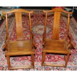 A pair of Chinese late 19th century official yoke back chairs.