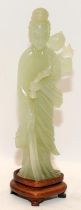 Chinese celadon Jade figure of Kwanyin holding a branch of peaches on original fitted hardwood stand