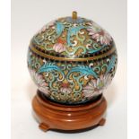 Oriental cloisonne lidded pot of small proportions on wooden stand 9x6cm