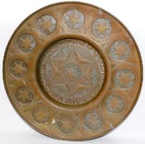 Large circular brass table top with star motif. 67cms across