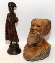 A carved wooden bust of an African gentleman c/w a wooden figure in Russian dress. Largest figure is