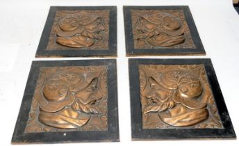 Four vintage cast metal tiles featuring bearded knights. Two matched pairs, possibly intended for