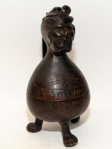 Bronze Holy Water pitcher in patinated decoration with a demon head set on tripod supports and