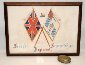 Framed pen and ink depicting the colours of the Second Somersetshire Regiment, c/w a trench art