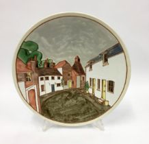 Poole Pottery interest large charger tube lined decorated depicting a street scene by Cynthia