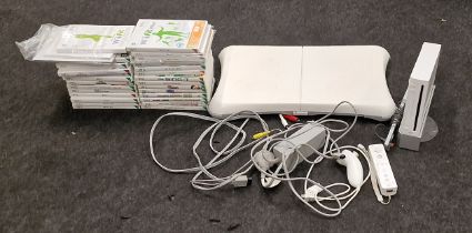 Nintendo Wii console with associated leads and controllers together with a Wii Fit board and a