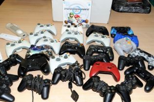 A carton of games controllers, various makes