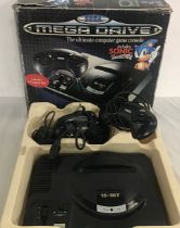 SEGA BOXED MEGA DRIVE GAME CONSOLE. This unit comes with 2 hand held wired controllers plus power