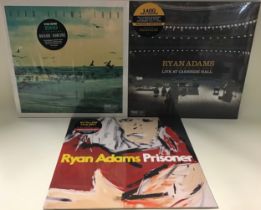 COLLECTION OF 3 X RYAN ADAMS VINYL ALBUMS. These are still factory sealed and include a red
