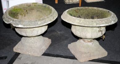 A pair of vintage reconstituted concrete garden urns. One requires restoration.