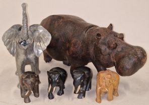 Mixed size carved African Elephants to include a large metal item together a carved Hippo