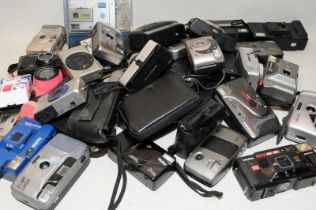 A large crate of modern 35mm compact cameras including leading brands