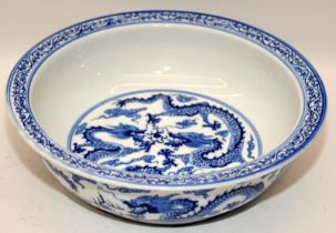 Large Chinese blue and white porcelain basin decorated with twin five claw dragons chasing pearl