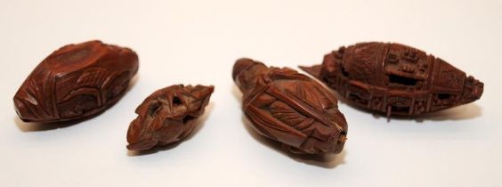 Four Chinese Oriental carve Coquilla nuts, one in the form of a Buddha (4cm) and a junk ship with