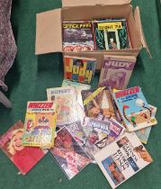 A box of vintage hardback annuals with a few comics.