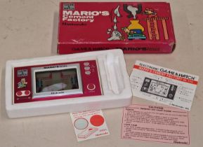 Nintendo vintage Game & Watch "Mario's Cement Factory" handheld game in original box with paperwork.
