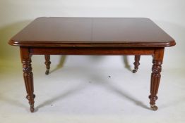 A Victorian mahogany wind-out dining table, moulded edge top and two extra leaves, raised on