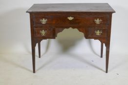 An C18th oak lowboy with long drawer over two small, with brass plate handles, raised on square