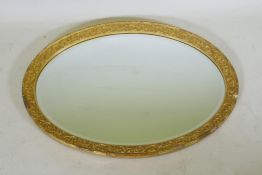 A gilt composition oval wall mirror, 59 x 86cm