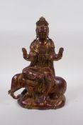 A Chinese coppered bronze of Quan Yin seated upon an elephant with the remnants of gilt patina, 32cm