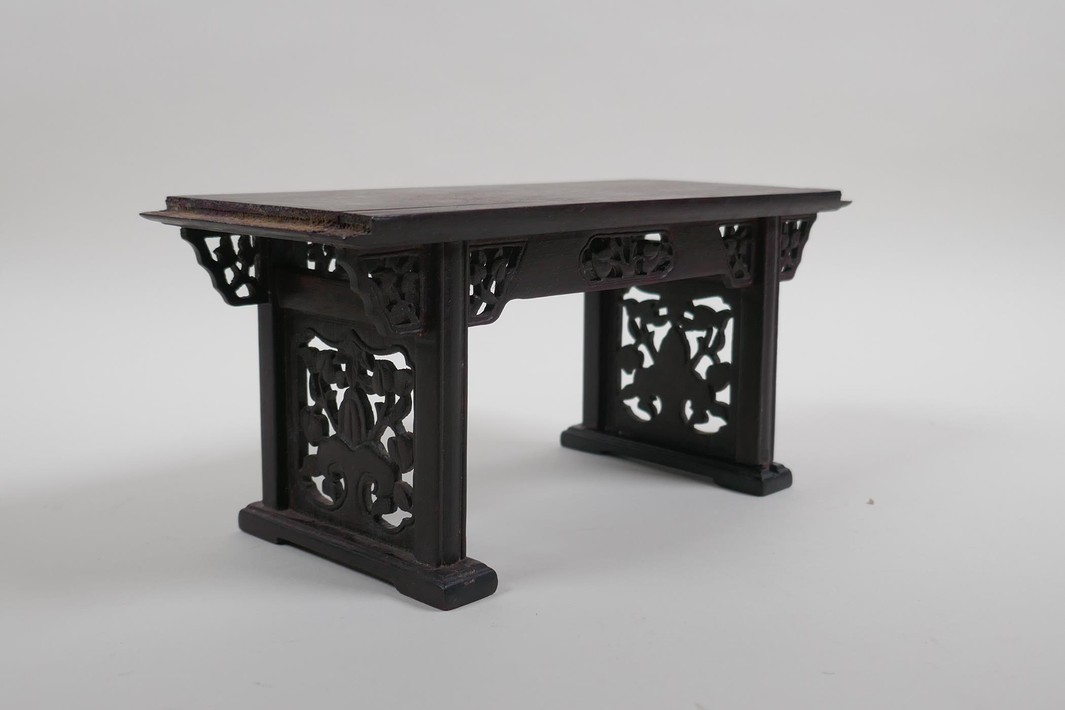 A Chinese carved and pierced hardwood stand in the form of a miniature altar table, 22cm wide - Image 4 of 4