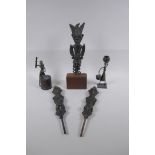 Three African benin bronze idols, one mounted, and two other benin bronzes of a water carrier and