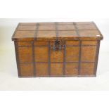 An antique Indian teak coffer with iron strapwork, carrying handles and hasps, 121 x 64 x 66cm