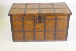 An antique Indian teak coffer with iron strapwork, carrying handles and hasps, 121 x 64 x 66cm