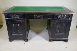 A C19th continental stained pine pedestal desk, with three drawers and two cupboards, one fitted