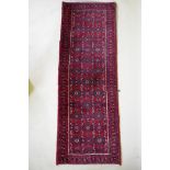 A Persian red ground full pile wool runner with an allover geometric design, 195 x 70cm